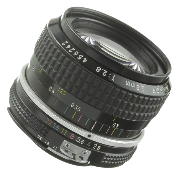 A close-up of a vintage camera lens showing the aperture and focus markings with various numerical values.